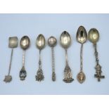 Seven silver & white metal novelty spoons, 71.2g