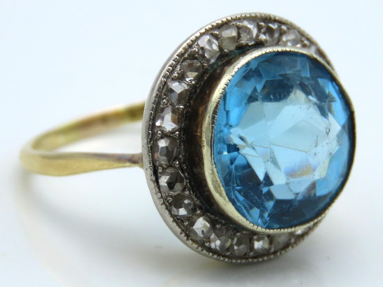An 18ct gold ring set with paste blue stone & 24 s