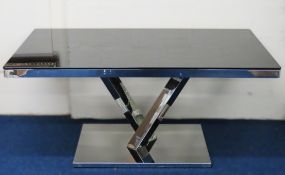 A glass topped table with polished alloy frame, 1600mm wide x 900mm deep x 750mm high