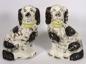 A pair of Victorian Staffordshire pottery spaniels