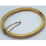 A 9ct gold bangle, 5.3g, some bumps, 66mm wide ext