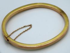 A 9ct gold bangle, 5.3g, some bumps, 66mm wide ext