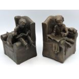 A pair of heavy bronze resin book ends featuring s