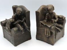 A pair of heavy bronze resin book ends featuring s