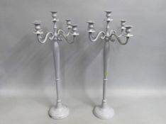 A pair of white wedding candelabra, some signs of usage, 783mm tall with a span of 360mm