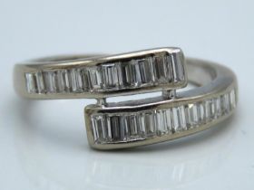 A white metal ring set with 22 baguette cut diamon
