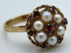 A 9ct gold ring set with pearl & garnet, stones cr