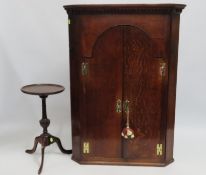 A 19thC. oak corner cupboard with brass fittings,