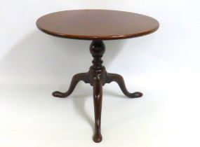 A 19thC. low level tilt top pedestal table, 585mm diameter x 480mm high