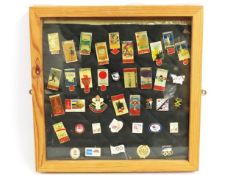 A framed collection of Olympic badges, 345mm squar