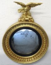 A Regency period convexed mirror with eagle surmou