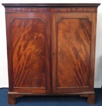 A 19thC. mahogany linen cupboard with pull out dra