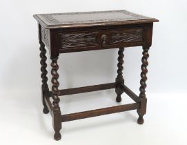 A 1920's oak table with barley twist legs & carved