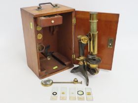 A cased brass microscope including slides