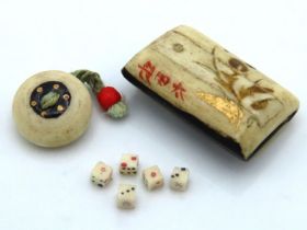 A Japanese miniature bone case containing dice, 19mm x 12mm