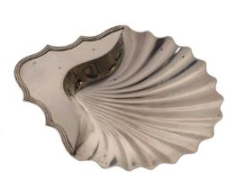 George III silver scallop-shaped butter dish standing on three shell feet