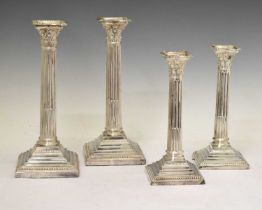 Two pairs of silver plated Corinthian column candlesticks
