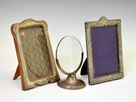 Three silver table-top photo frames