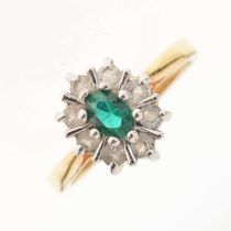 Dress ring set green oval cut centre stone within a border of white stones