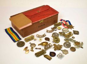 Second World War medal pair and cap/uniform badges