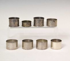 Set of four Edward VII silver napkin rings, and four other silver napkin rings