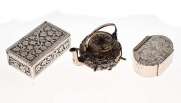 Two foliate decorated silver boxes and a Chinese white metal miniature kettle