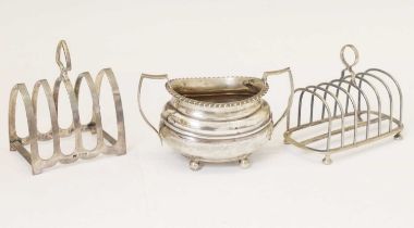 Two silver toast racks and a George V silver sugar basin