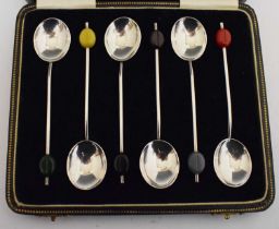 Cased set of six George V silver demi-tasse coffee spoons with coloured 'bean' terminals