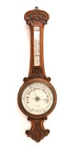 Early 20th century carved oak aneroid barometer and thermometer