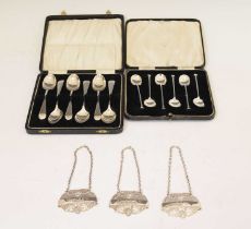 Two cased sets of silver teaspoons/coffee spoons, and a set of three decanter labels