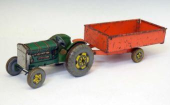 Mettoy Playthings tinplate clockwork tractor with red trailer