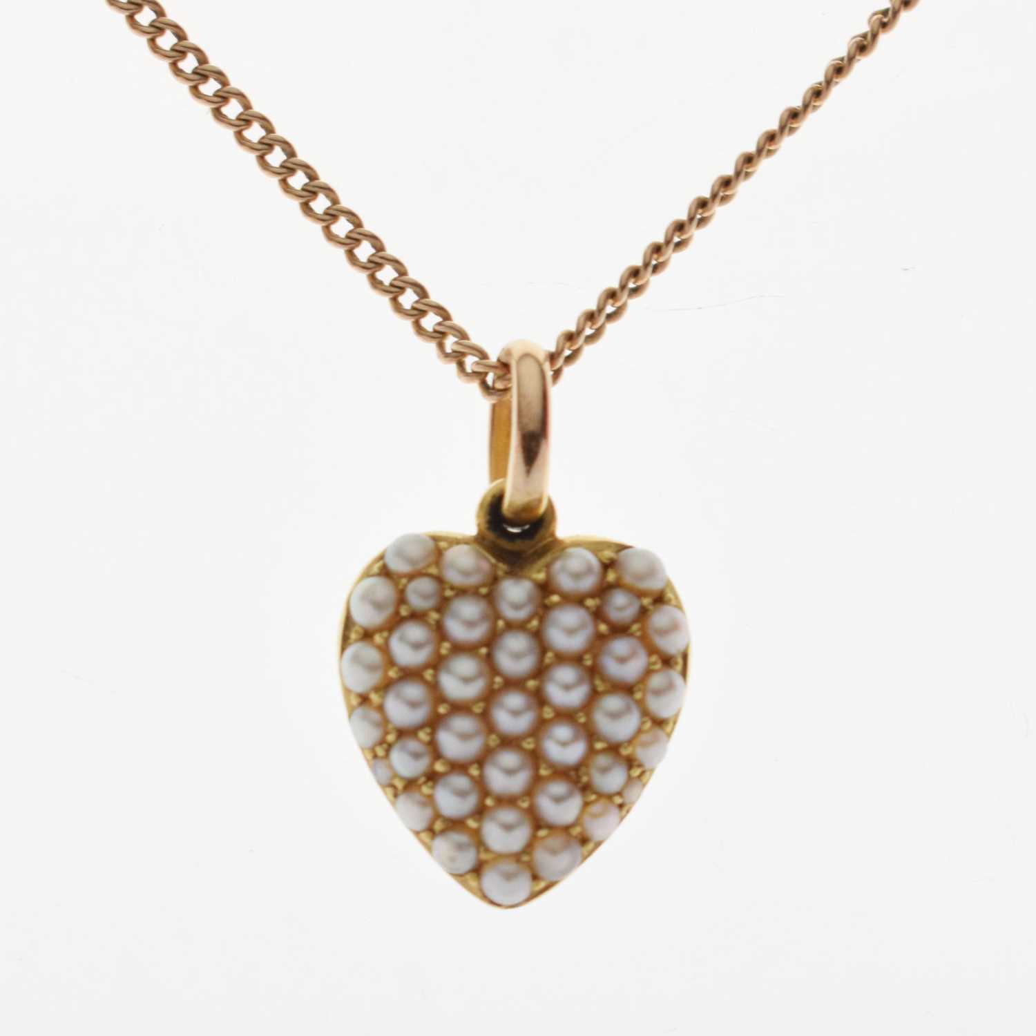 Yellow metal heart shaped pendant set seed pearls