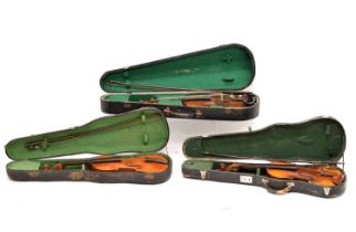 Three cased violins