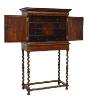 Early 18th century inlaid walnut cabinet on later stand