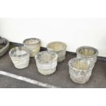 Set of four composite stone garden planters and a pair of composite stone planters