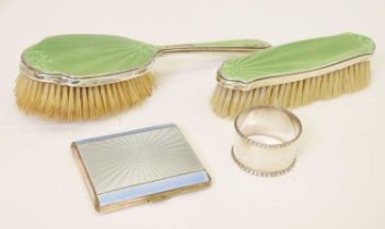 Two George V silver mounted and green enamel dressing brushes, etc