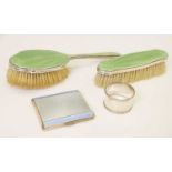 Two George V silver mounted and green enamel dressing brushes, etc