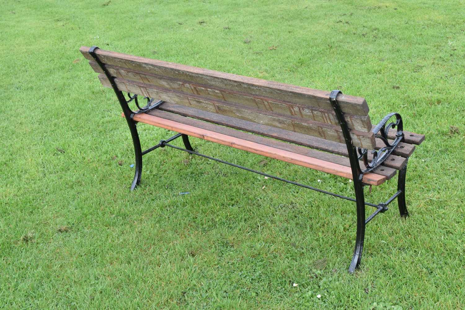 Modern two seater teak garden bench with cast metal ends - Image 5 of 6