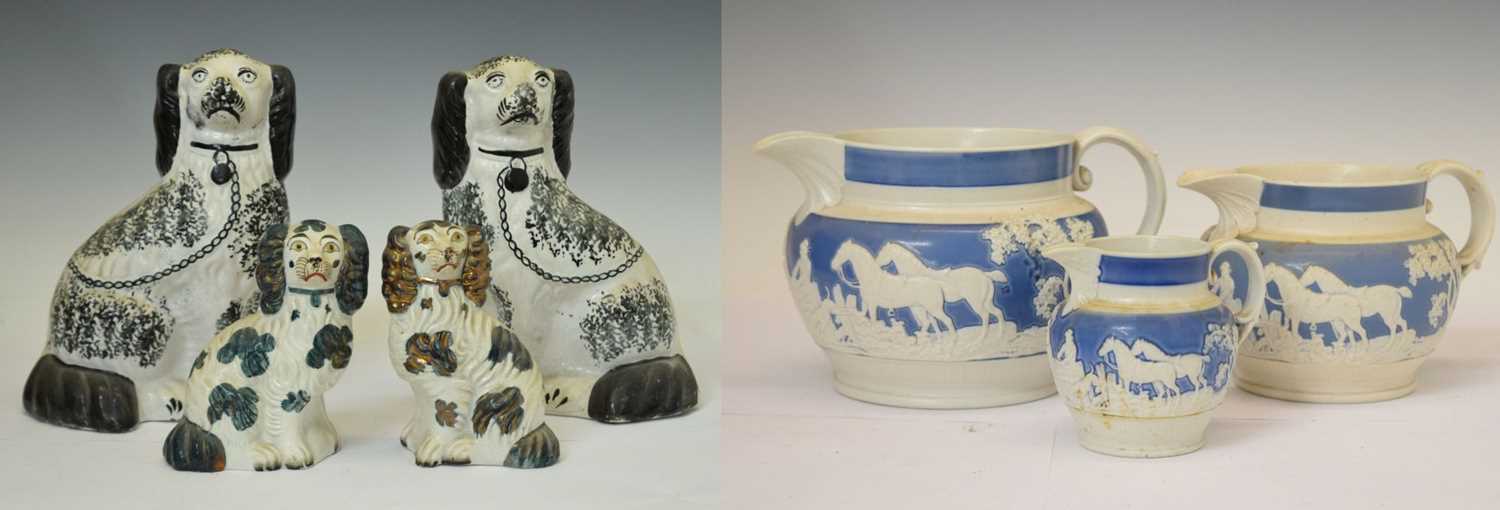 Two pairs of Staffordshire spaniels, together with three hunting jugs