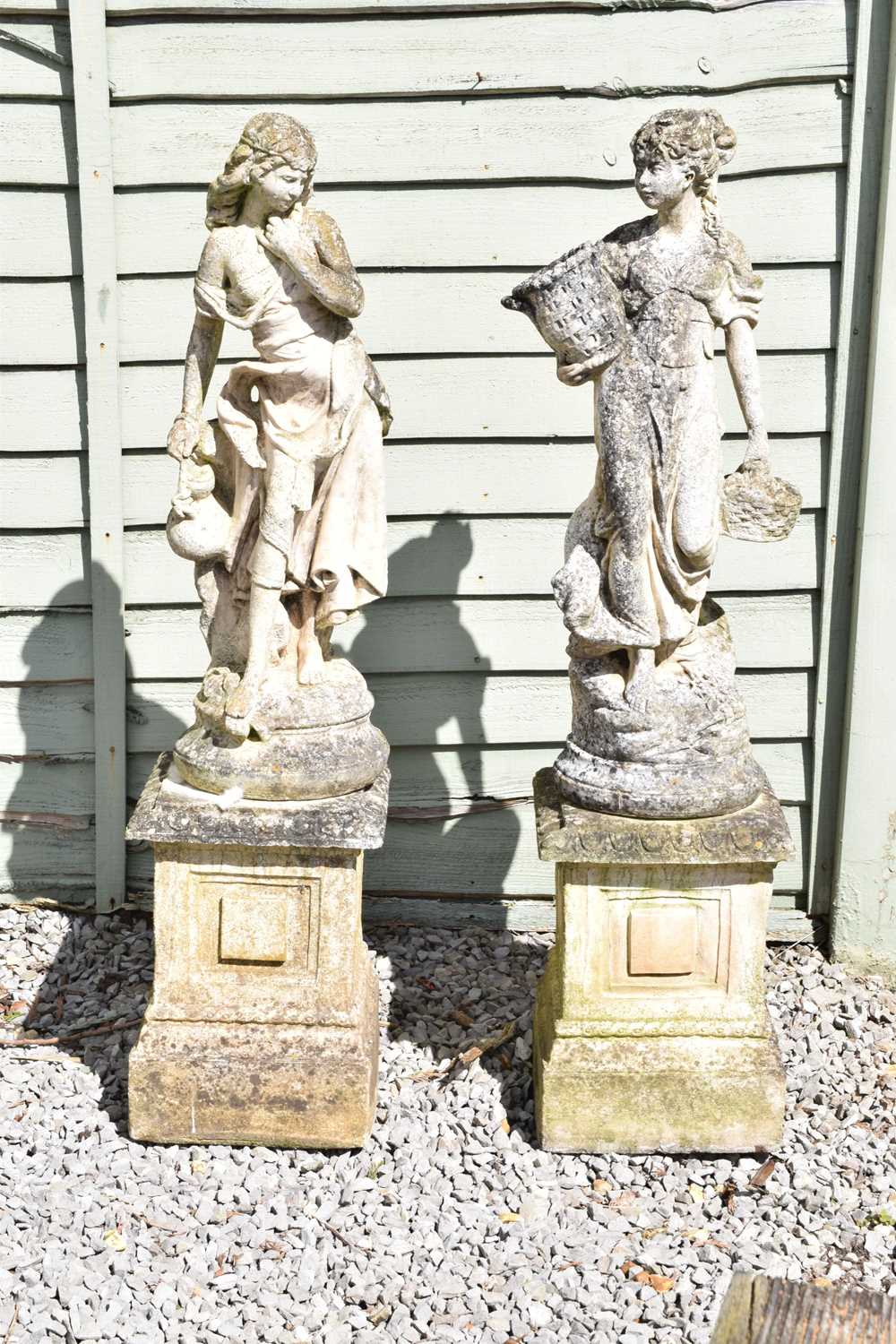 Two large composition stone garden statues of classical maidens