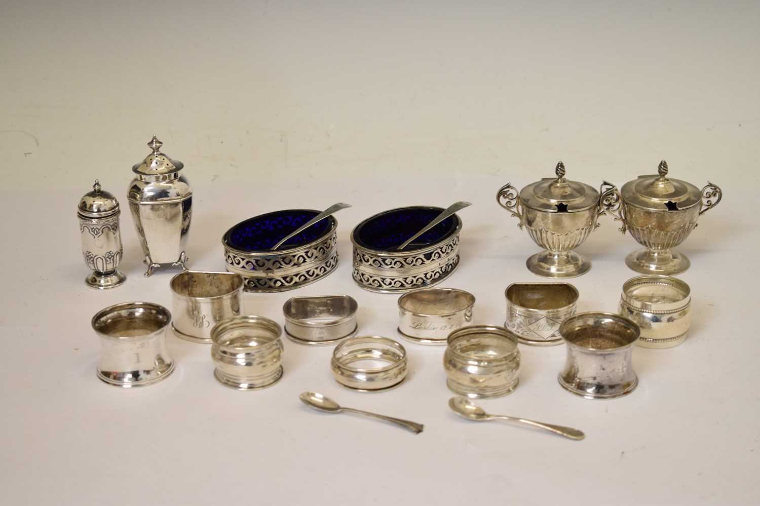 Collection of silver items to include silver napkin rings, pair of silver of pedestal mustard pots