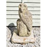 Composition stone garden ornament of a perched owl