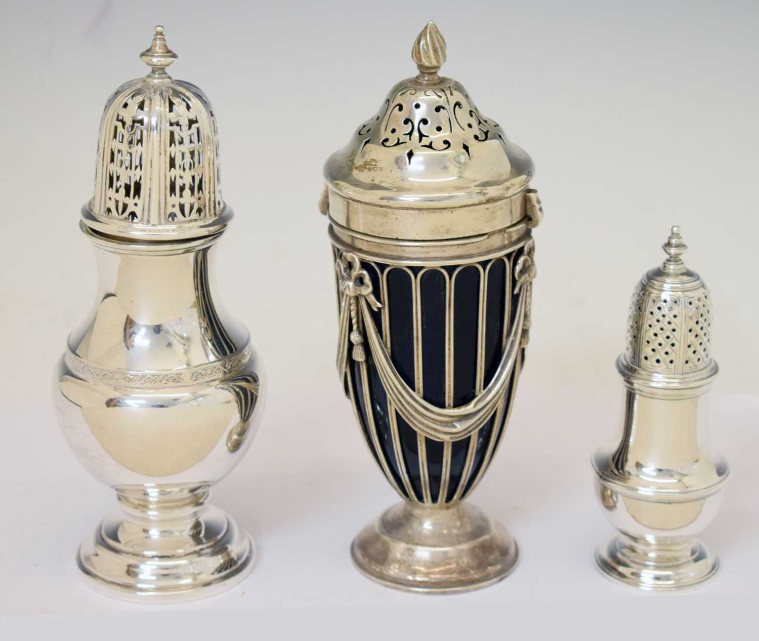 George II silver pepperette, George V sugar sifter, and an Edward VII vase-shaped sifter