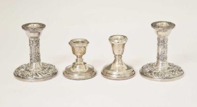 Two pairs of Elizabeth II silver candlesticks