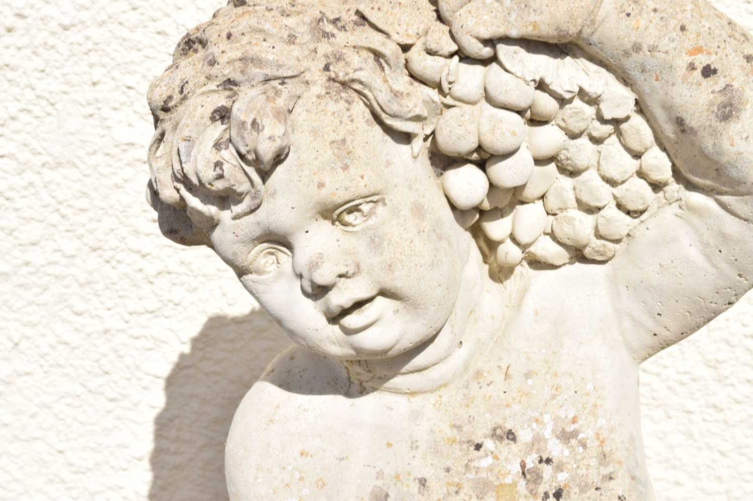 Composite stone garden statue of a cherub holding grapes - Image 5 of 7