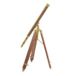 Reproduction brass cased telescope, on a wooden tripod stand