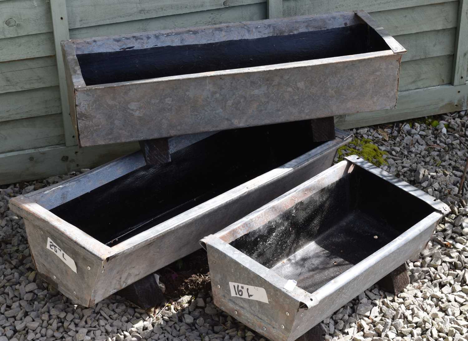 Three galvanised metal garden troughs