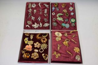 Four trays of vintage costume brooches