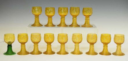 Fourteen 19th century German amber glass roemers
