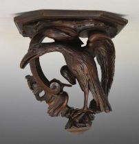 Carved wood wall bracket depicting a perched stylised bird